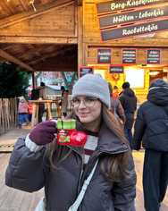 Me at a Christmas market, holding a Santa boot mug.
